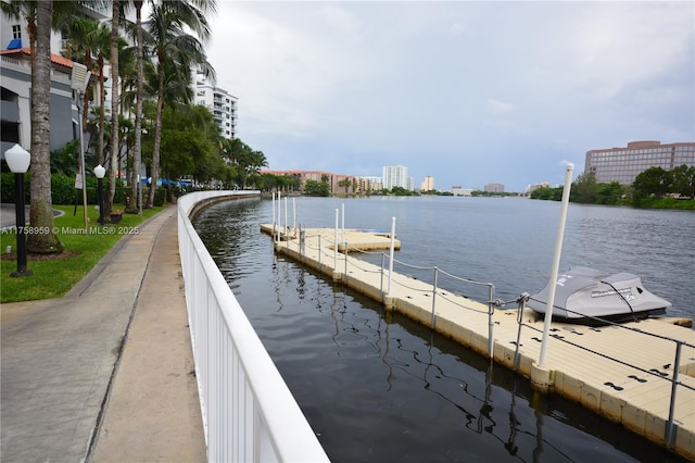 dock area featuring a water view and a view of city