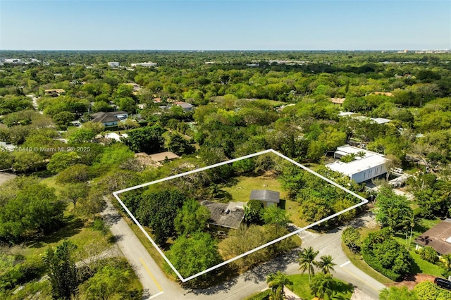 birds eye view of property with a wooded view