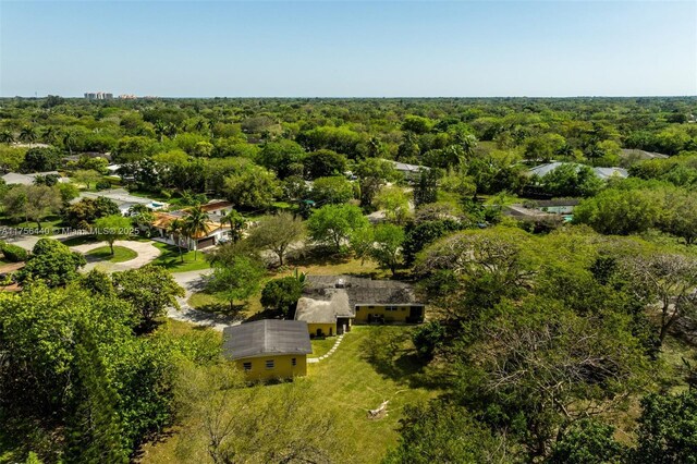 birds eye view of property featuring a view of trees