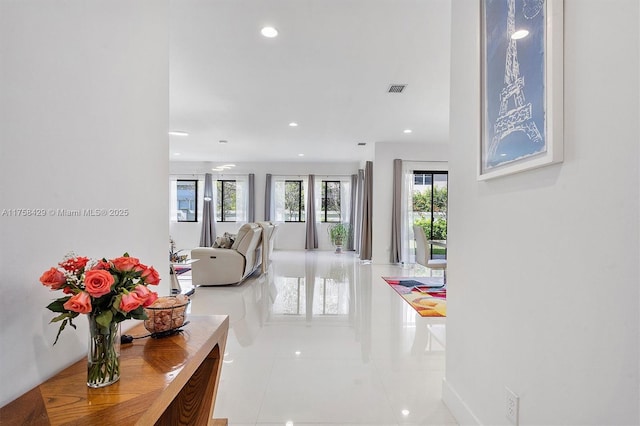 hallway with visible vents, tile patterned flooring, and recessed lighting