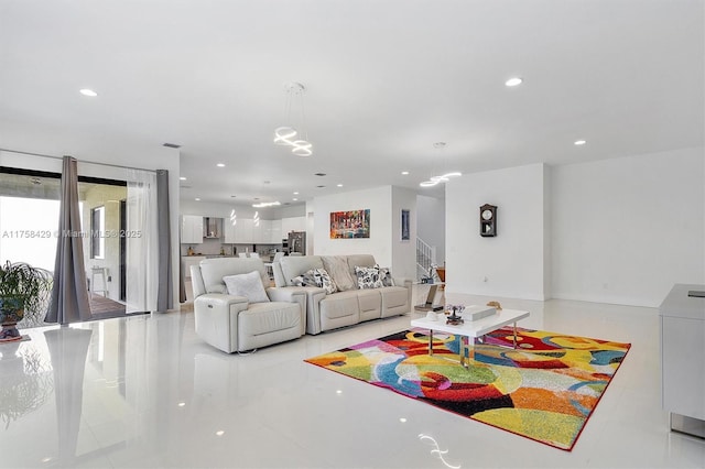 living room featuring stairs, a chandelier, and recessed lighting