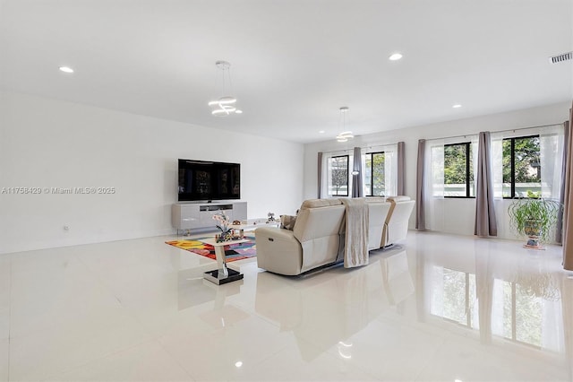 tiled living room with visible vents and recessed lighting