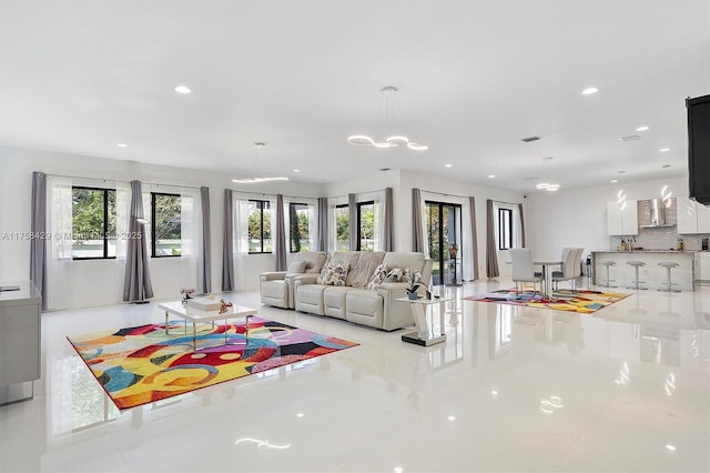 living area featuring plenty of natural light, visible vents, and recessed lighting