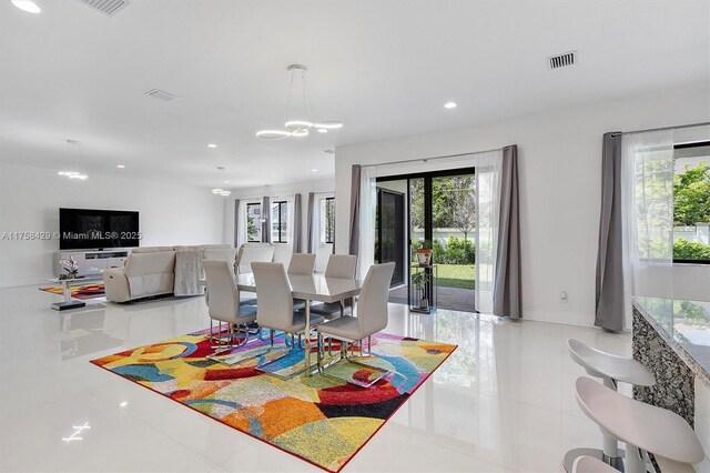 tiled dining room with an inviting chandelier, recessed lighting, baseboards, and visible vents
