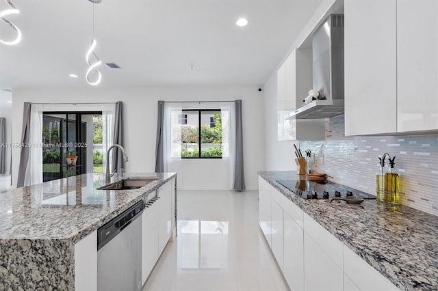 kitchen featuring a sink, wall chimney exhaust hood, stainless steel dishwasher, modern cabinets, and black electric stovetop