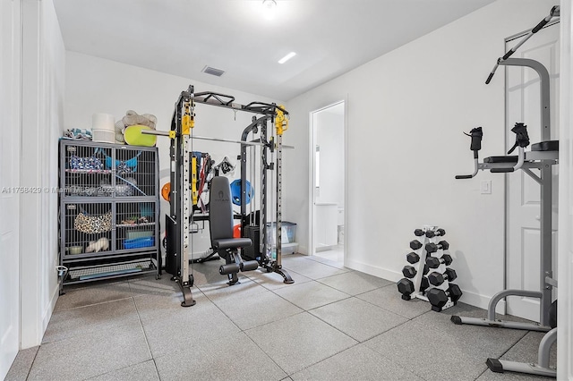 exercise area with baseboards and visible vents
