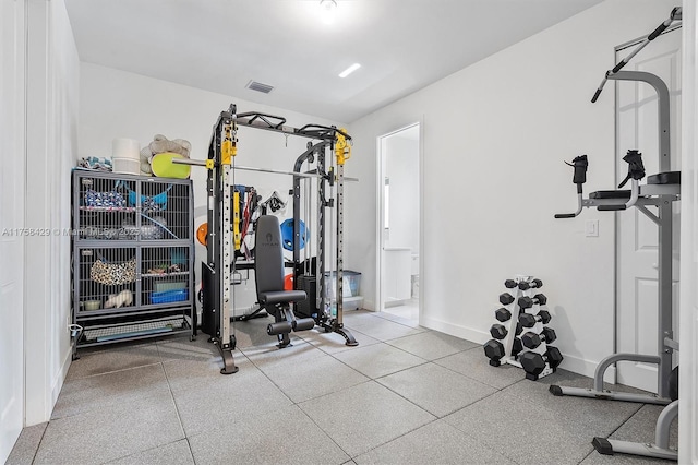 exercise room featuring visible vents and baseboards