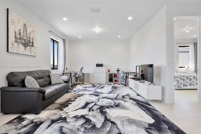 living area featuring visible vents and recessed lighting