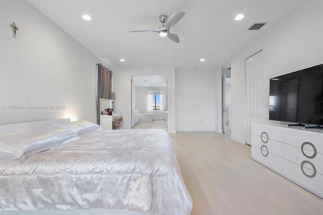 bedroom with light wood-style floors, visible vents, ensuite bathroom, and recessed lighting