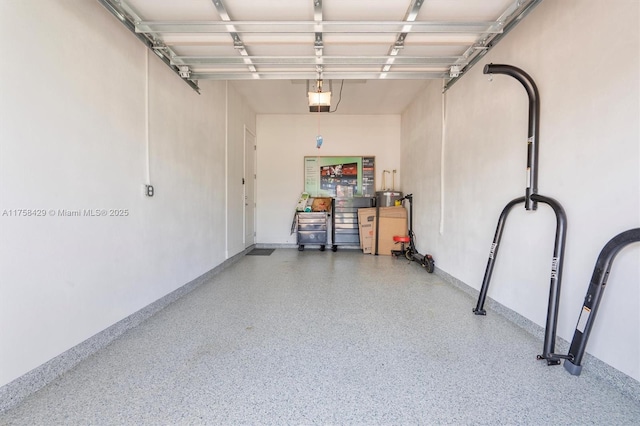 garage with baseboards and a garage door opener