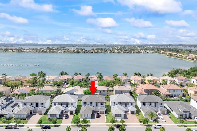 drone / aerial view featuring a residential view and a water view