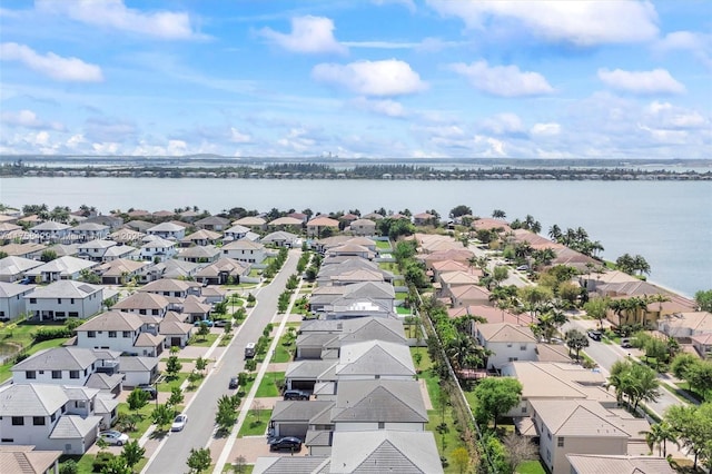 drone / aerial view with a residential view and a water view