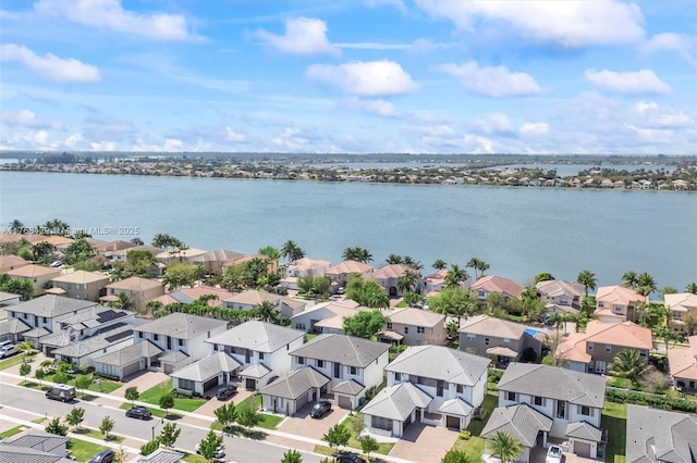 birds eye view of property with a residential view and a water view