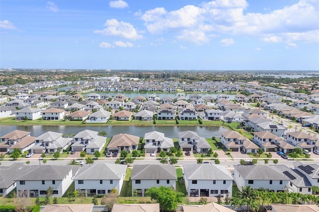 birds eye view of property with a water view and a residential view