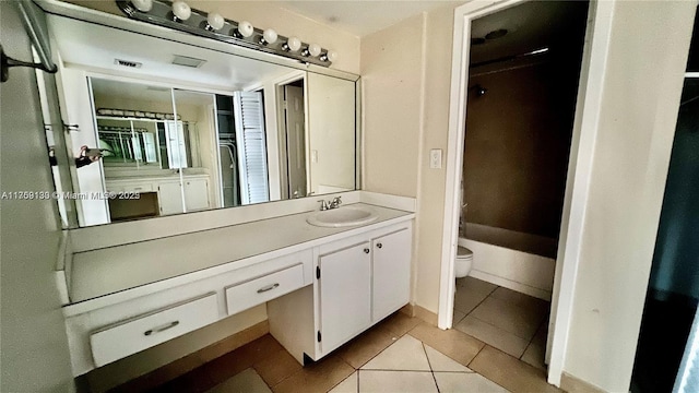 full bath with vanity, toilet, and tile patterned floors