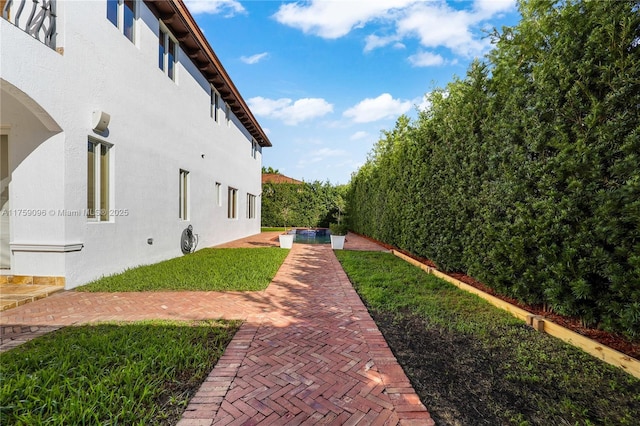 view of yard with a fenced backyard, an outdoor pool, and a patio