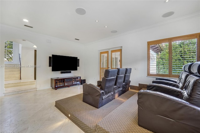 living room featuring ornamental molding, arched walkways, visible vents, and recessed lighting