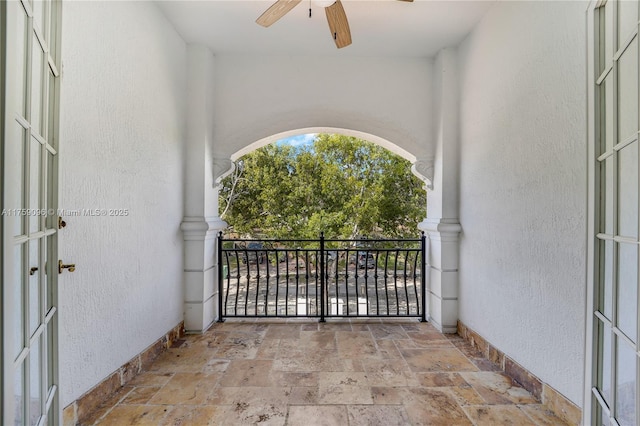 view of gate with ceiling fan