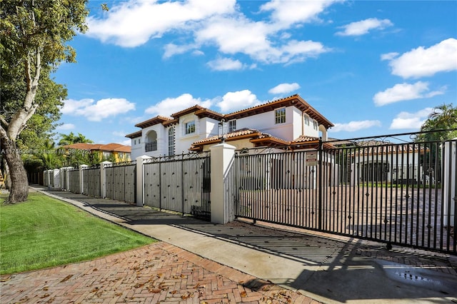 view of gate featuring a fenced front yard and a yard