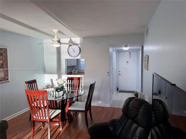 dining area with wood finished floors, a ceiling fan, baseboards, and visible vents