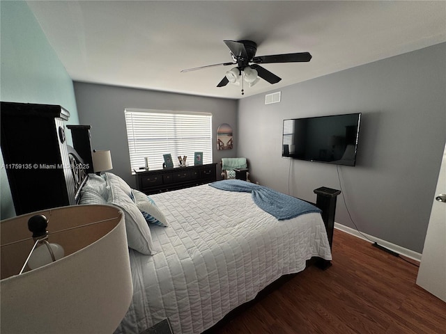 bedroom with ceiling fan, visible vents, baseboards, and wood finished floors