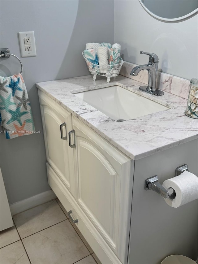 bathroom featuring tile patterned floors, baseboards, and vanity