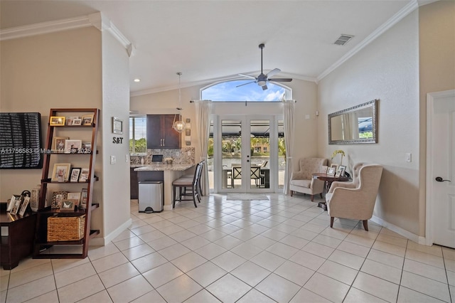 entrance foyer featuring light tile patterned flooring, visible vents, vaulted ceiling, french doors, and crown molding