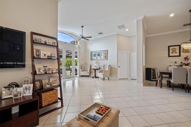 living area with light tile patterned floors, high vaulted ceiling, a ceiling fan, and crown molding