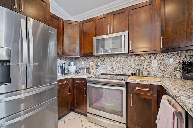 kitchen with stainless steel appliances, light tile patterned floors, crown molding, and tasteful backsplash