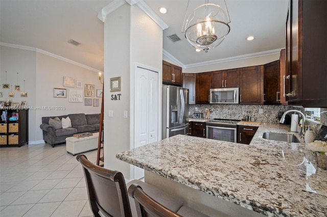 kitchen featuring light stone counters, light tile patterned floors, visible vents, appliances with stainless steel finishes, and a sink