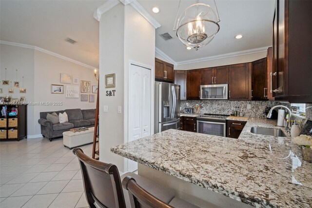 kitchen featuring decorative backsplash, light stone counters, crown molding, a sink, and light tile patterned flooring