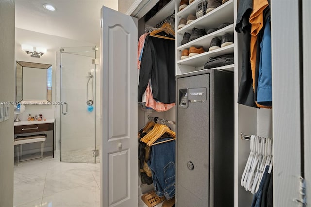 walk in closet with marble finish floor