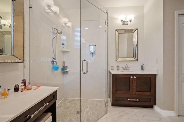 bathroom featuring marble finish floor, a stall shower, vanity, and baseboards