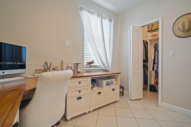 office area with light tile patterned floors and baseboards