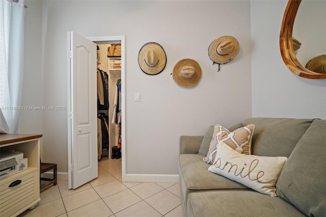 living area featuring baseboards and light tile patterned floors