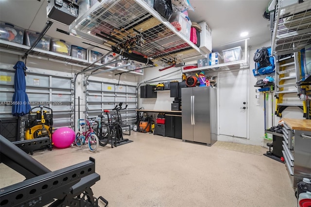 garage with freestanding refrigerator and a garage door opener