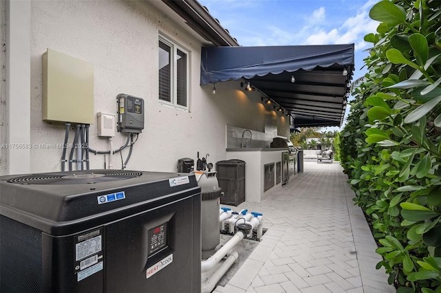 view of patio / terrace with cooling unit and area for grilling