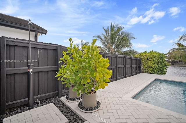 view of patio / terrace with a fenced in pool and fence private yard