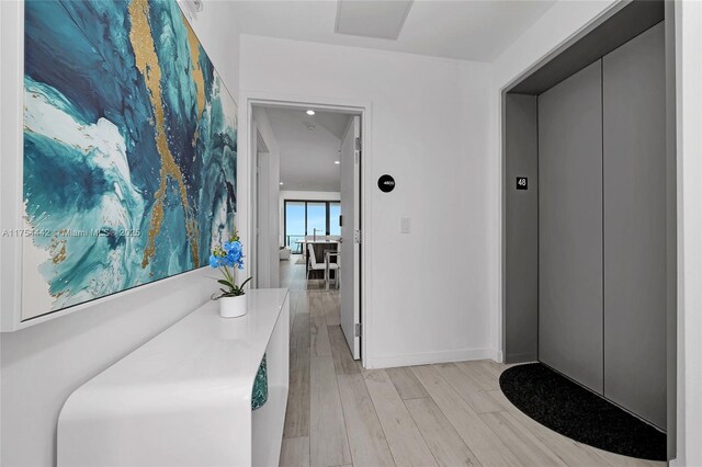 480 NE 31st St Unit 4805, Miami, FL 33137 - corridor with elevator, baseboards, and light wood-type flooring