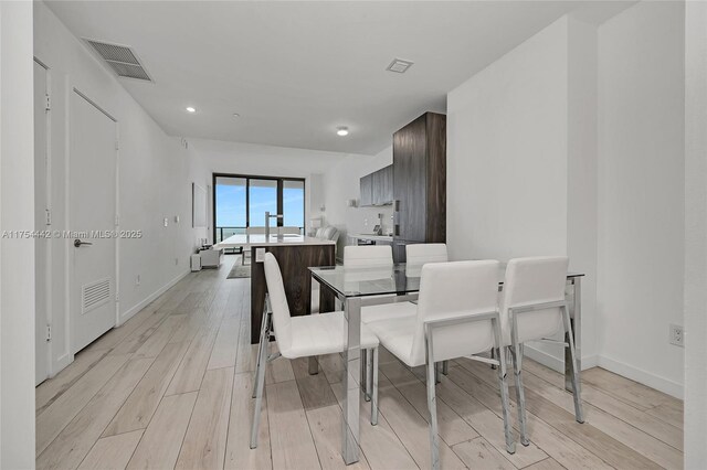 480 NE 31st St Unit 4805, Miami, FL 33137 - dining room with light wood-type flooring, visible vents, and baseboards