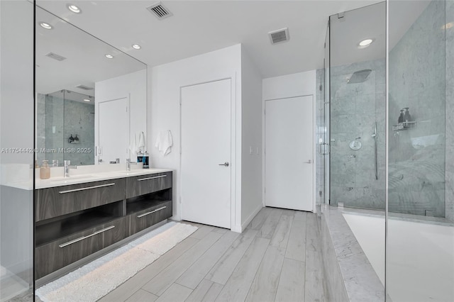 480 NE 31st St Unit 4805, Miami, FL 33137 - bathroom featuring a sink, wood finished floors, visible vents, and a stall shower