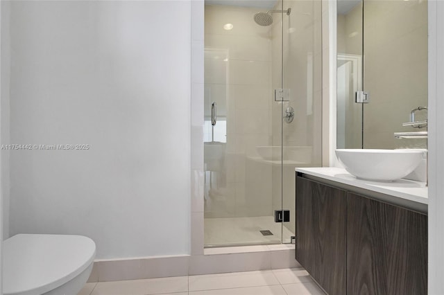 full bath featuring tile patterned flooring, toilet, a shower stall, and vanity