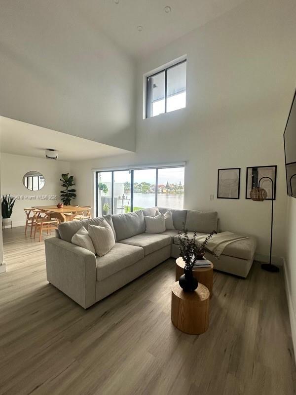 living area featuring a high ceiling and wood finished floors