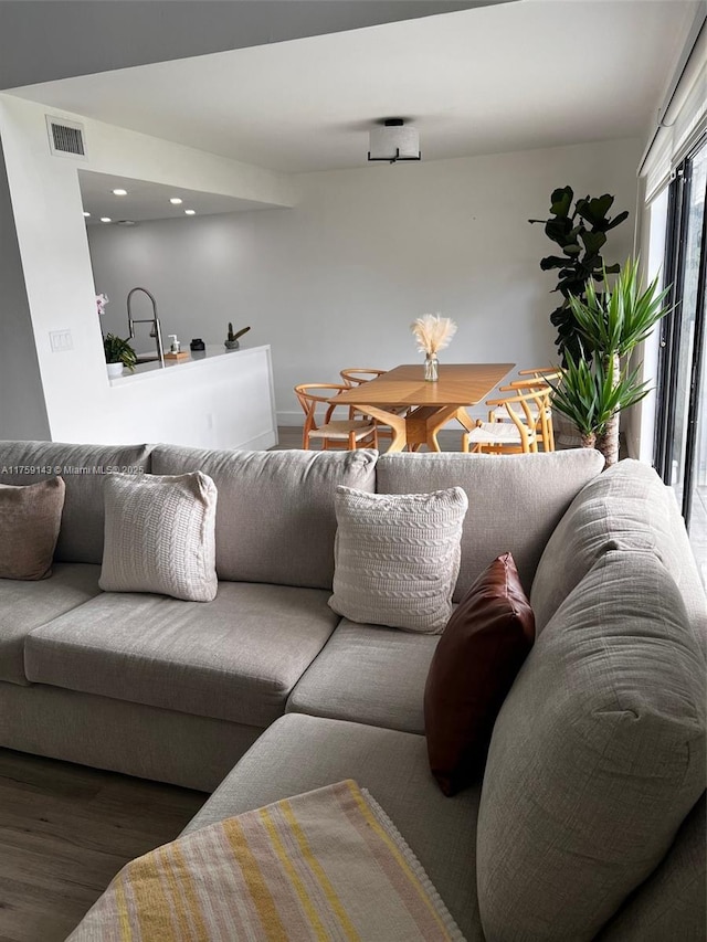 living area featuring visible vents, wood finished floors, and recessed lighting