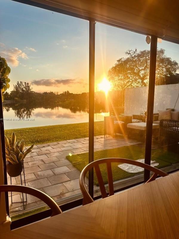 unfurnished sunroom featuring a water view