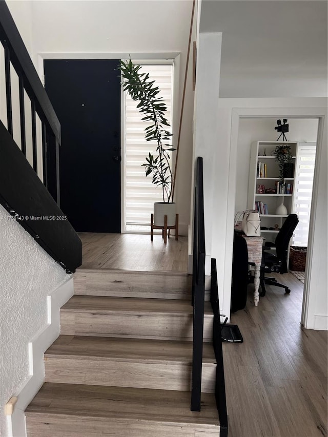 stairway with wood finished floors