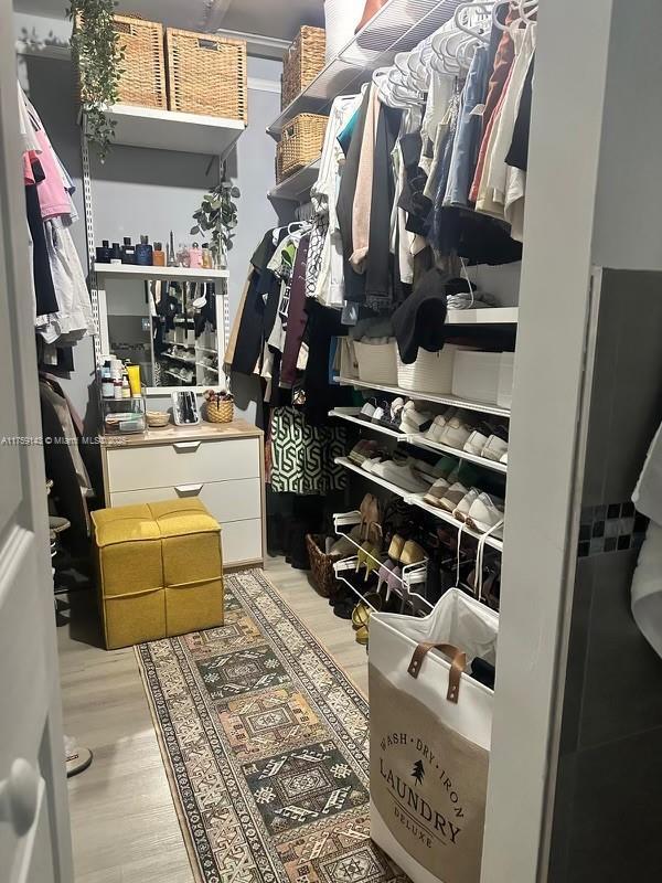 spacious closet featuring wood finished floors