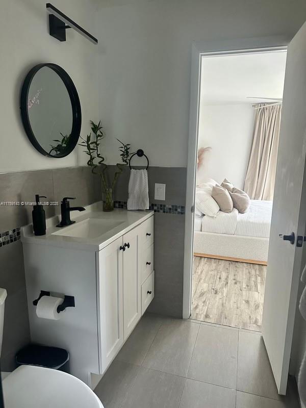 bathroom featuring toilet, vanity, and tile patterned floors