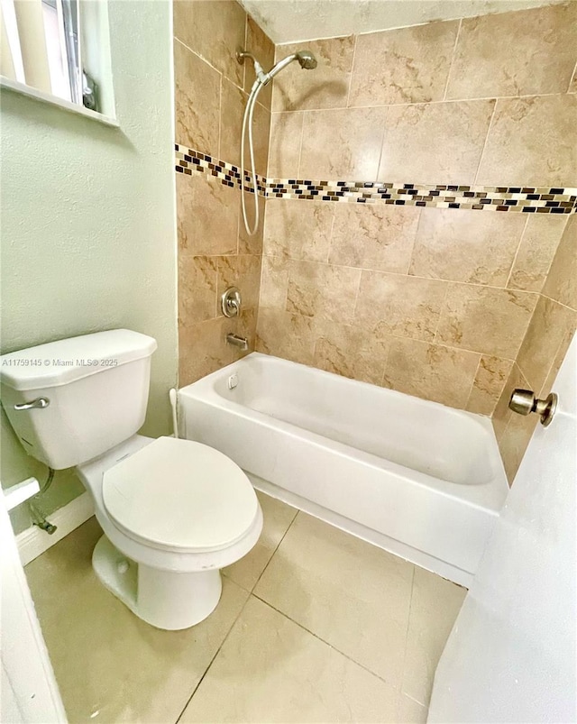 full bath featuring tile patterned floors, toilet, and shower / bathtub combination