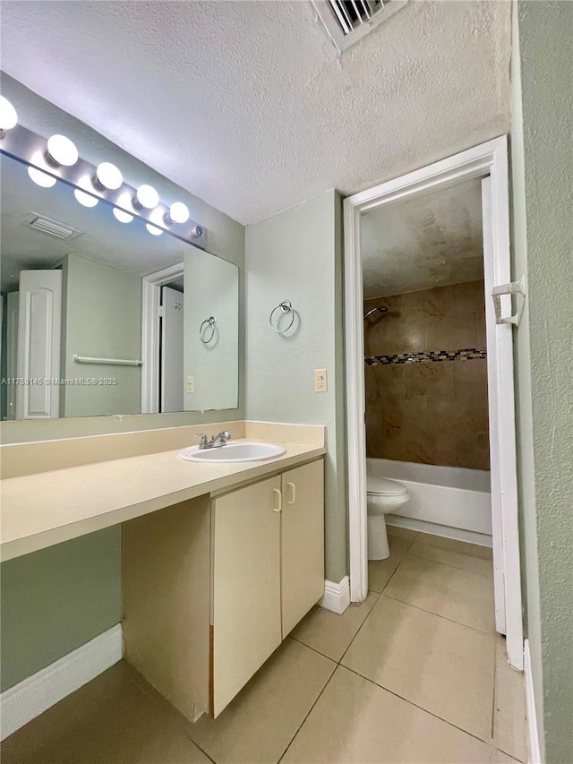 full bathroom featuring vanity, visible vents, a textured ceiling, tile patterned floors, and toilet